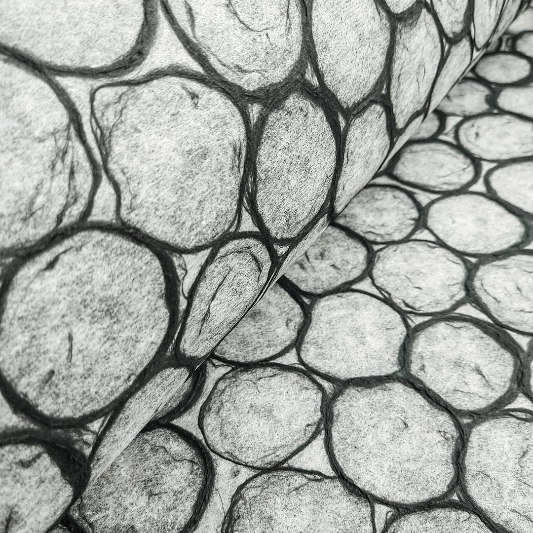 Decorative handmade paper by Kozo Studio featuring an abstract beehive design made of black-edged circles on translucent mulberry paper, great for art and design projects.