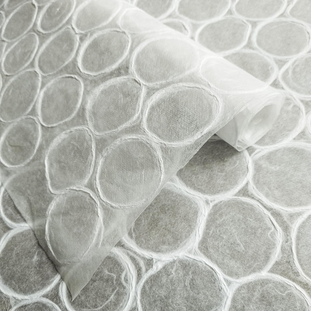 Translucent Kozo Studio handmade paper with layered circular textures and visible fibers, reflecting the natural beauty of traditional mulberry paper.