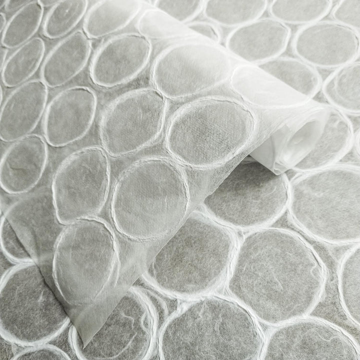 Translucent Kozo Studio handmade paper with layered circular textures and visible fibers, reflecting the natural beauty of traditional mulberry paper.