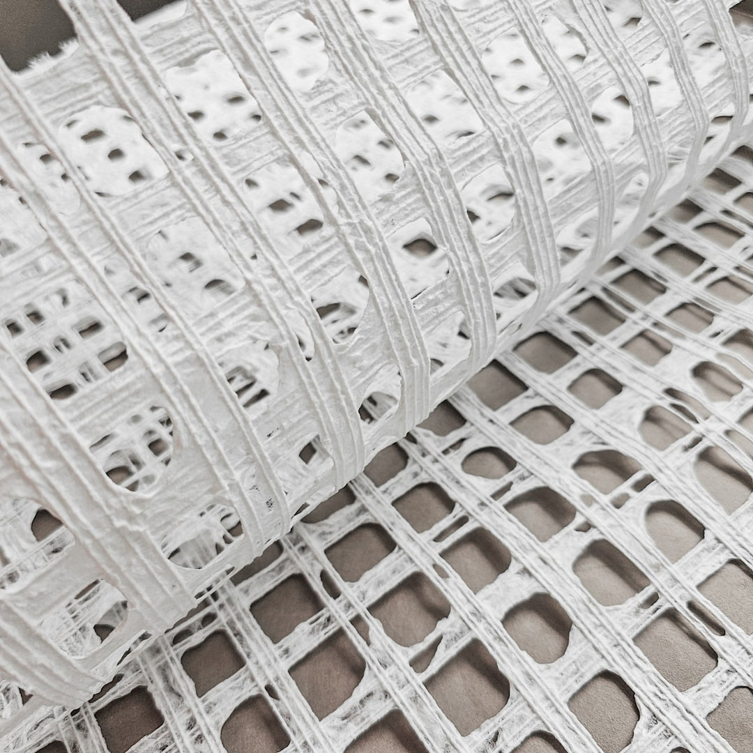 Kozo Studio white handmade paper made from mulberry fibers, with a subtle plaid pattern crafted by skilled artisans using cotton threads.