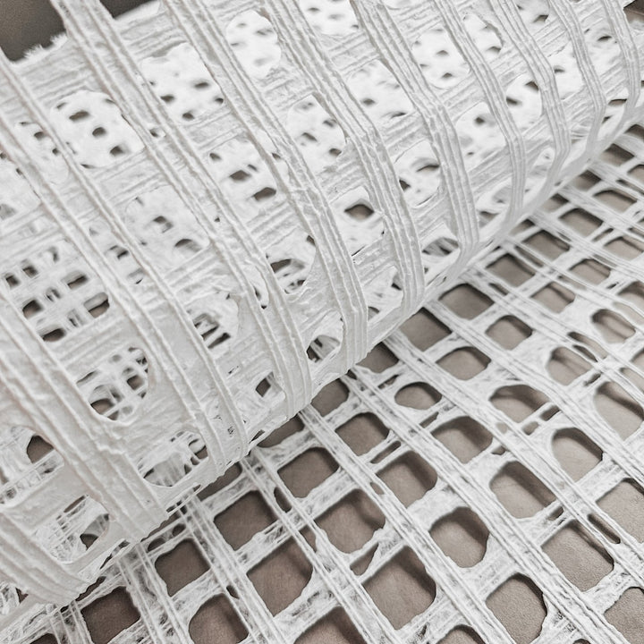 Kozo Studio white handmade paper made from mulberry fibers, with a subtle plaid pattern crafted by skilled artisans using cotton threads.