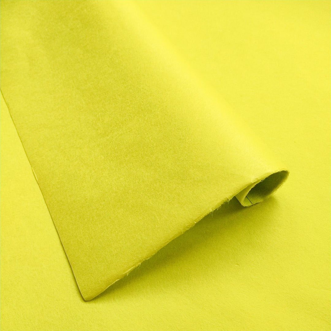 Close-up of Limeade solid-colored handmade paper from Kozo Studio showing the soft texture and smooth surface of premium mulberry paper.