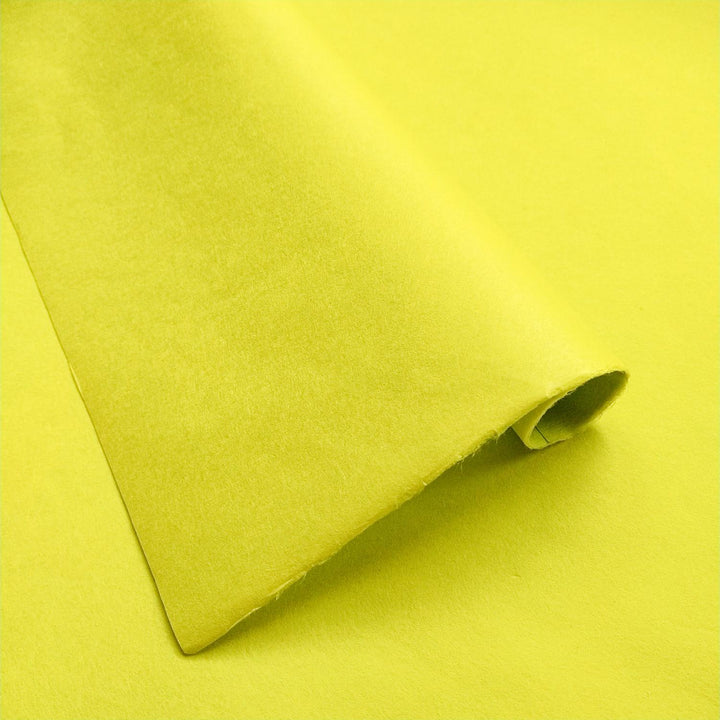 Close-up of Limeade solid-colored handmade paper from Kozo Studio showing the soft texture and smooth surface of premium mulberry paper.