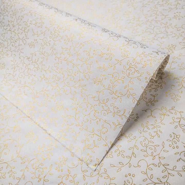 Unrolled sheet of Grapevine Screen-printed handmade paper from Kozo Studio featuring a gold floral design on white mulberry paper with elegant vines and leaves.