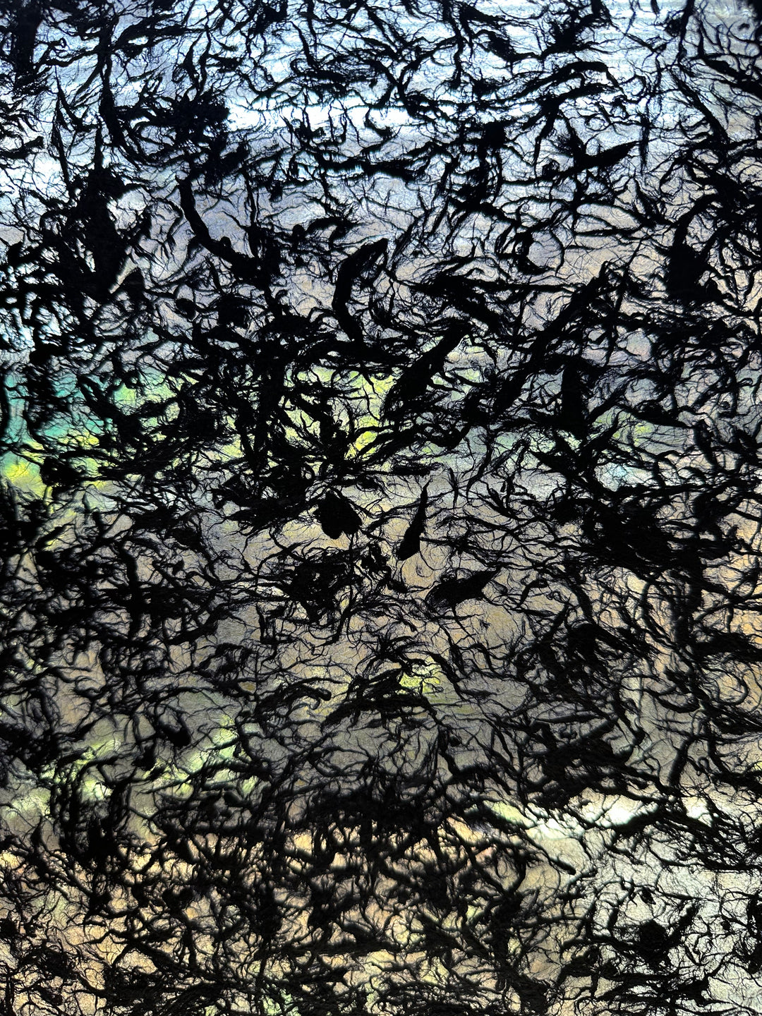 Translucent black handmade paper made from mulberry fibers at Kozo Studio, blending strength and elegance with floating fiber textures for refined artistic expression.