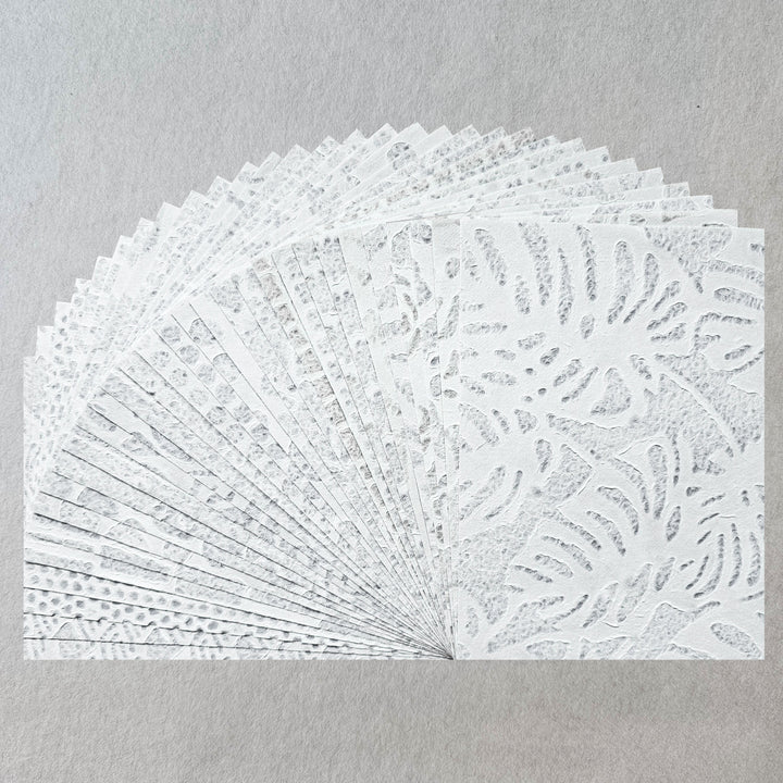Handmade lace mulberry paper pack from Kozo Studio featuring 15 intricate Rakusui designs, ideal for crafts, collages, and invitations.