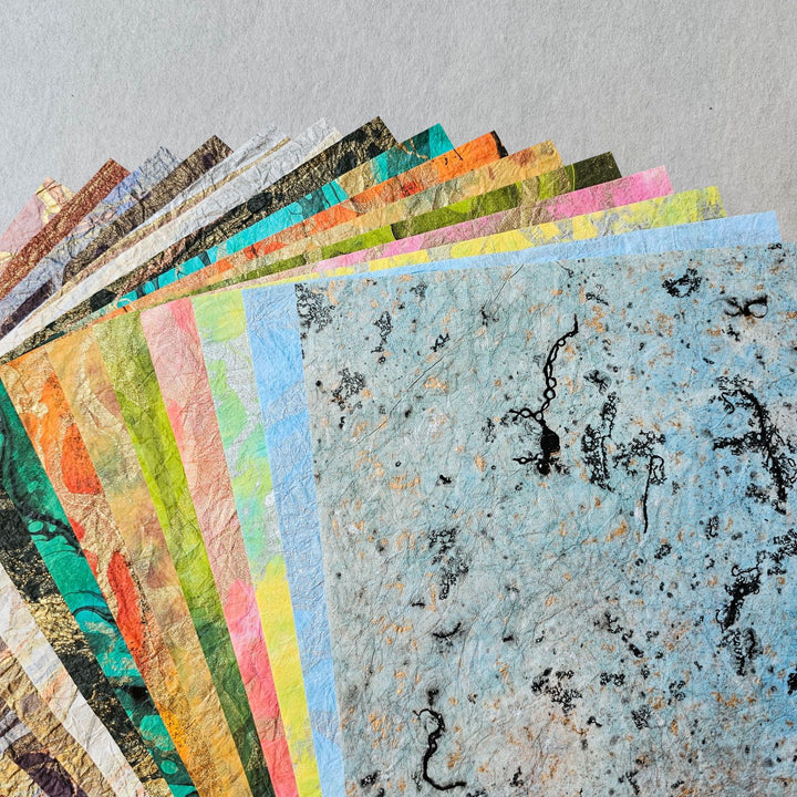 Close-up image of Milano Kozo handmade paper featuring swirling marble designs on soft-textured mulberry paper, handcrafted individually at Kozo Studio.