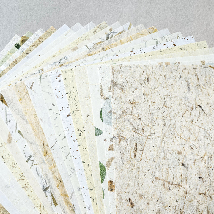 Detailed photo of a handmade paper pack by Kozo Studio, including unique mulberry paper types like Coco Confetti, Bamboo Confetti, and Full Mulberry Bark Unryu, perfect for creative projects.