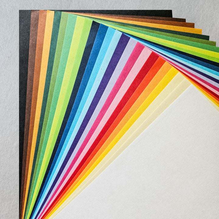 Premium solid-color mulberry paper from Kozo Studio, showcasing 24 rich tones in a 48-sheet pack, great for artists and crafters seeking quality handmade paper for various DIY and design applications.