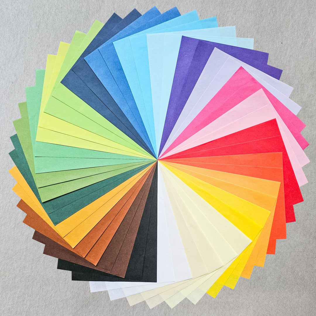A colorful assortment of handmade Kozo Studio mulberry paper, acid-free and ideal for card making, collage, and creative crafting, with a smooth texture and subtle kozo fiber patterns.