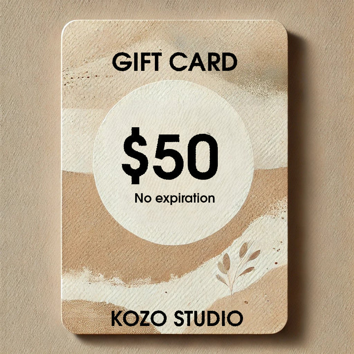 The Kozo Studio Gift Card: Share the Gift of Creativity offers $50 with rice paper-like beige and brown abstract patterns with a small plant illustration in the bottom right. This timeless gift card from Kozo Studio has no expiration, making it a perfect present.