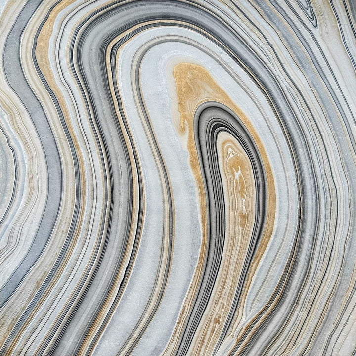 Marble Kozo Paper Design 1 by Kozo Studio displayed in close-up, showing layered mulberry paper with curled edge and natural, stone-like textures in soft neutral tones.