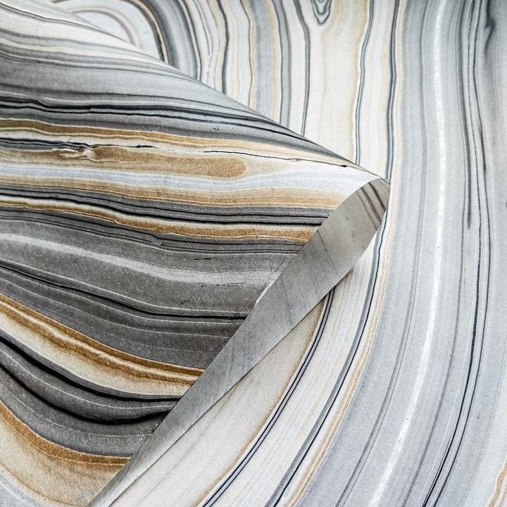Handmade Marble Kozo Paper from Kozo Studio showcasing natural wave patterns and rich earth tones, crafted from traditional mulberry paper for artistic projects.