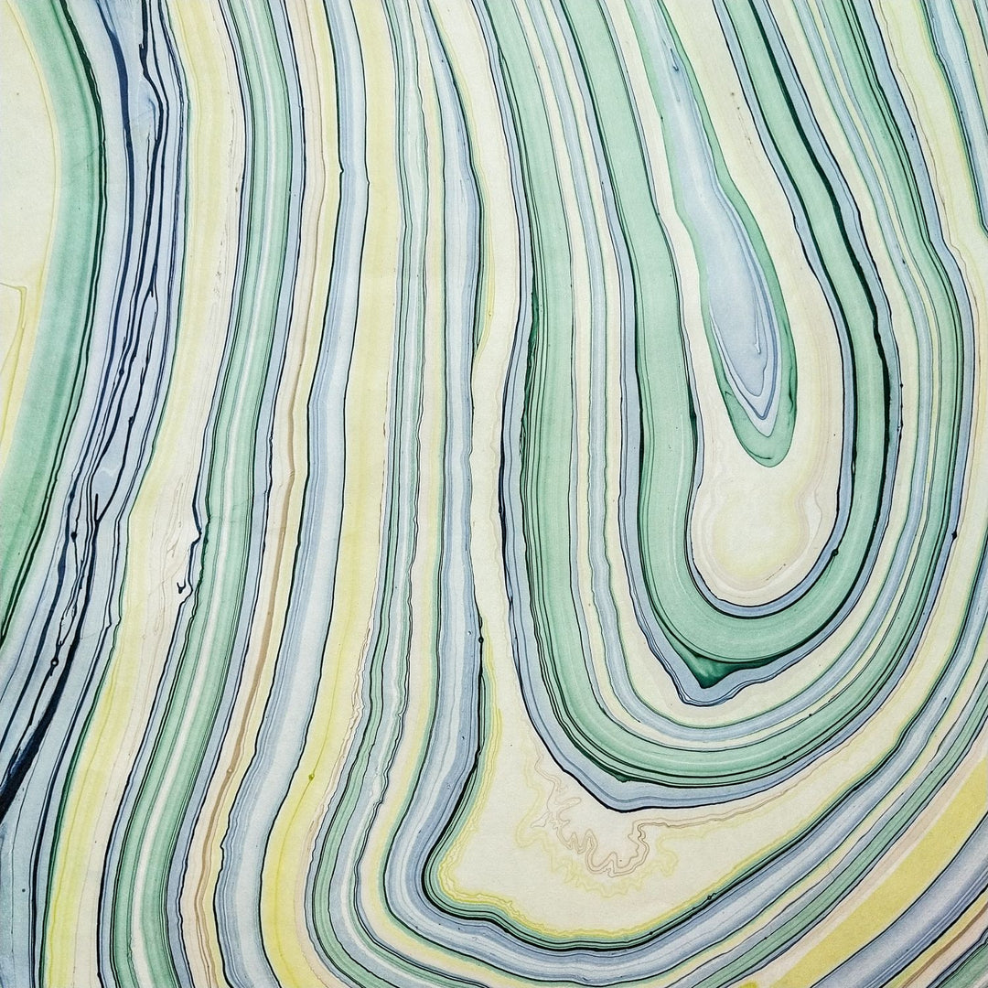 Kozo Studio Marble Design 3 handmade paper crafted from mulberry fiber. The swirling blue, green, yellow, and cream lines create a dynamic visual perfect for fine paper lovers and craft projects.