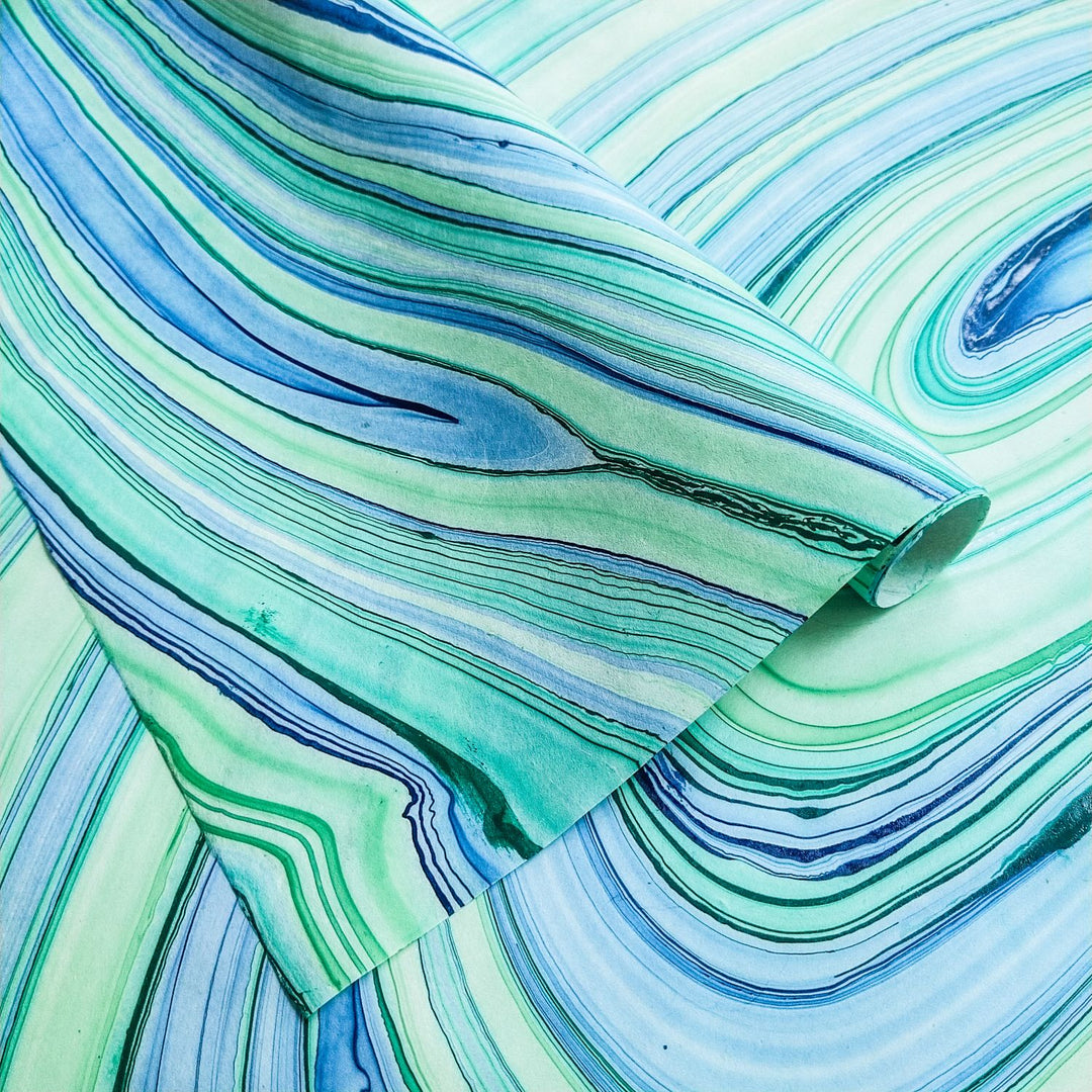 Close-up of Marble Kozo Paper Design 4 by Kozo Studio featuring swirling blue, green, and turquoise lines on handmade mulberry paper, ideal for art and craft projects.