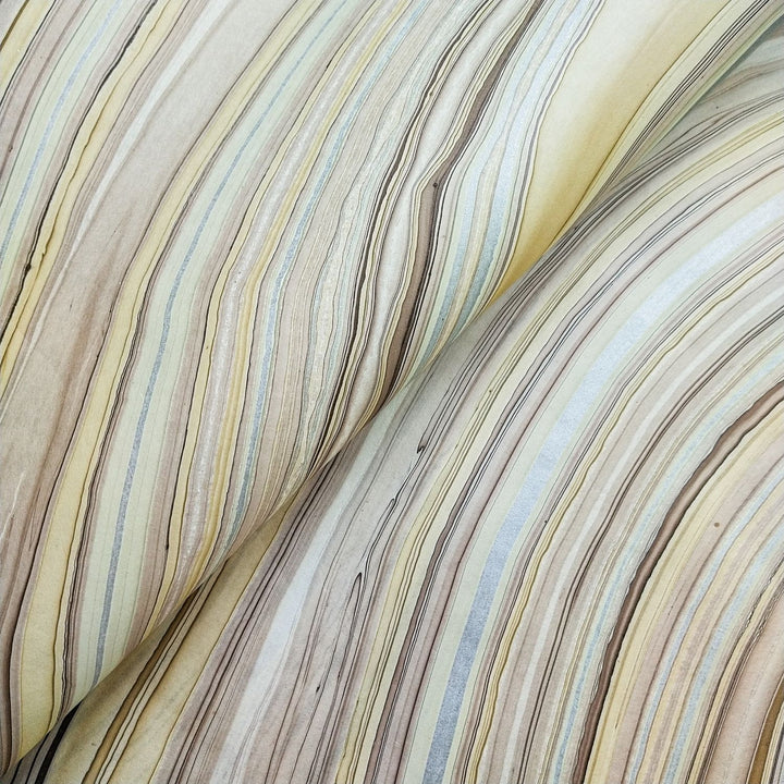 Artistic swirl patterns in brown, silver, and beige on handmade marble kozo paper from Kozo Studio, perfect for craft and art projects.