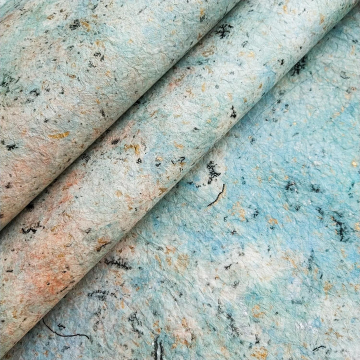 :
Handmade paper from Kozo Studio featuring Design 1 of Milano Kozo Paper, crafted with mulberry paper marbled in swirling oil colors and hand-crumpled for a unique, fabric-like texture.