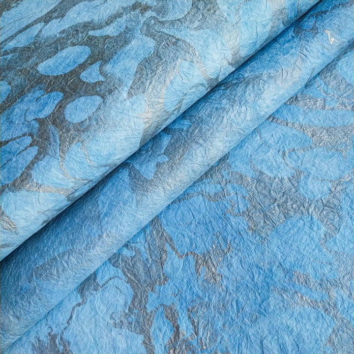 Handmade mulberry paper from Kozo Studio featuring graceful marbled patterns and soft, fabric-like textures perfect for artistic and decorative projects.