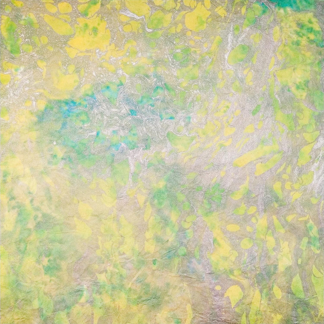 The Milano Kozo Paper - Design 3 by Kozo Studio features an abstract blend of green, yellow, and blue hues on top of a Mulberry Paper. Its swirling patterns create a fluid sense of movement and depth.