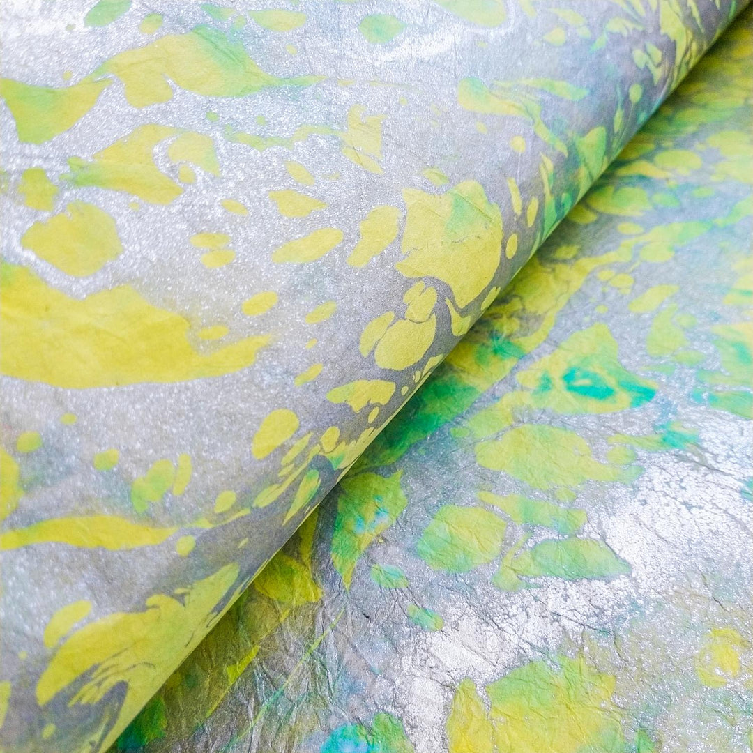 Graceful marbled mulberry paper by Kozo Studio showcasing soft textures and organic creases in this handmade paper design.