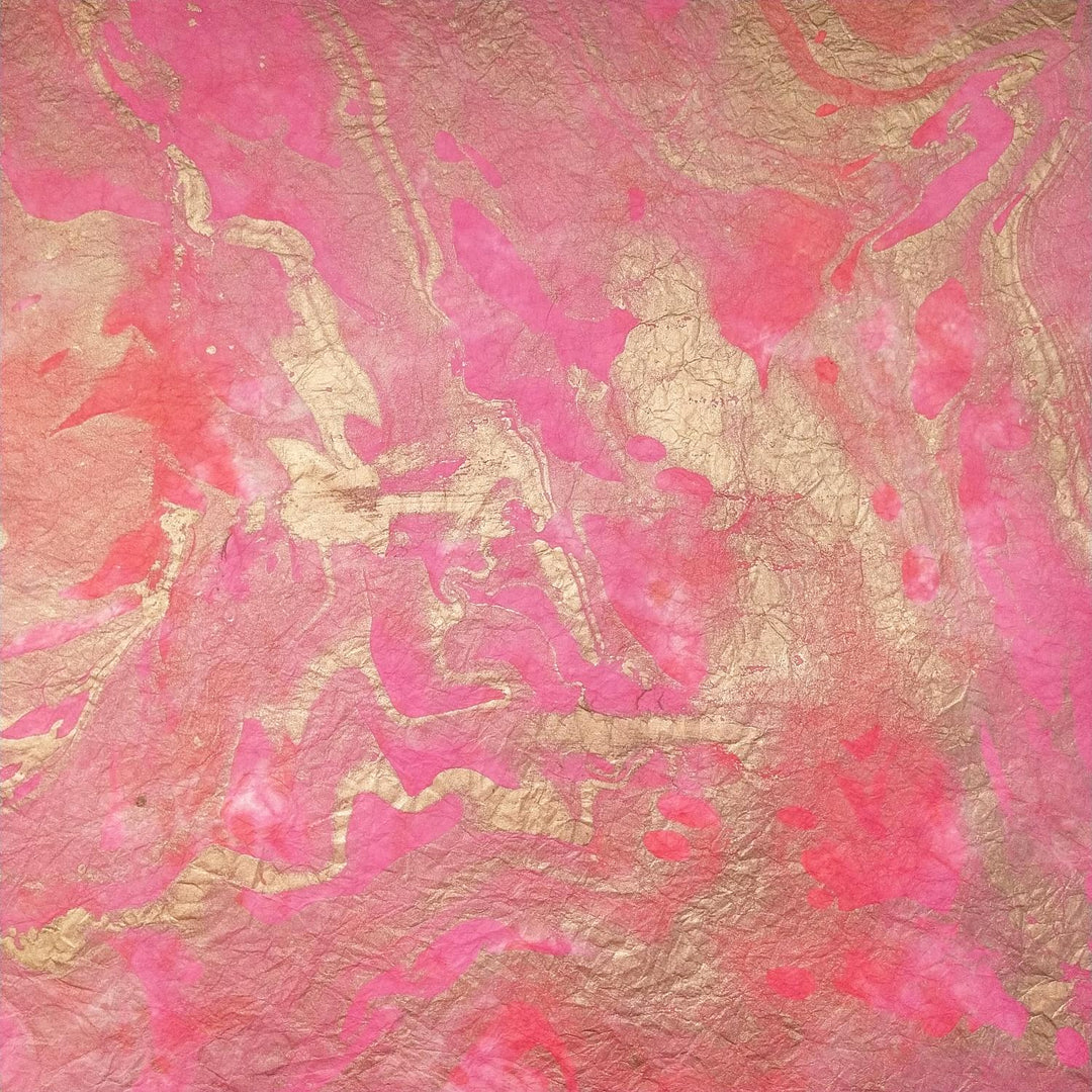 The Milano Kozo Paper - Design 4 by Kozo Studio features a marble-like pattern with pink and gold swirls on delicate mulberry paper, blending smoothly for an artistic and elegant appearance.
