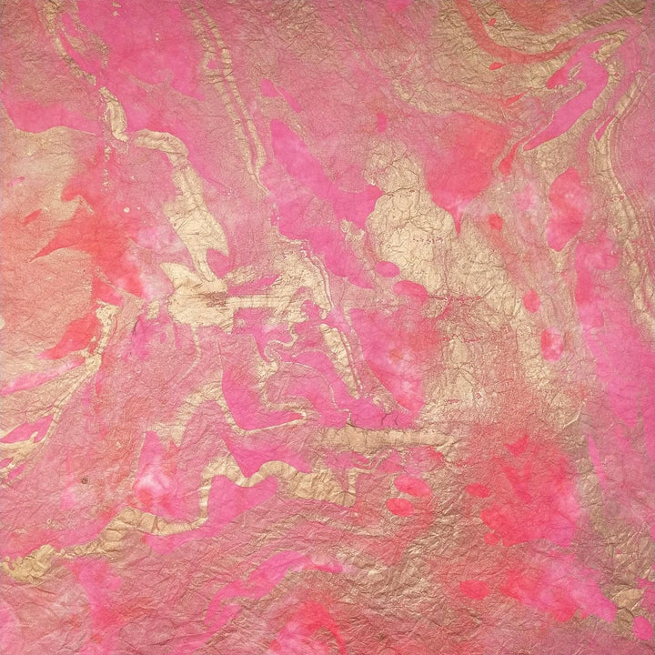The Milano Kozo Paper - Design 4 by Kozo Studio features a marble-like pattern with pink and gold swirls on delicate mulberry paper, blending smoothly for an artistic and elegant appearance.