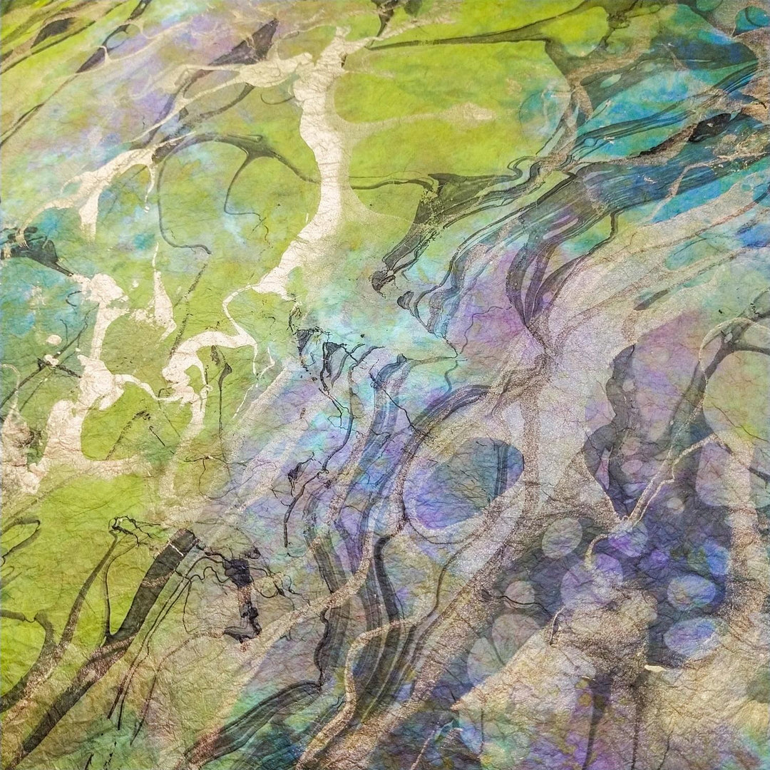 Vibrant marbled handmade paper crafted with mulberry fibers by Kozo Studio, highlighting a unique blend of texture and visual depth.
