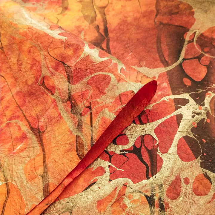 Kozo Studio handmade mulberry paper featuring an abstract blend of red, yellow, and black with silver accents, capturing the elegance of artisanal design.