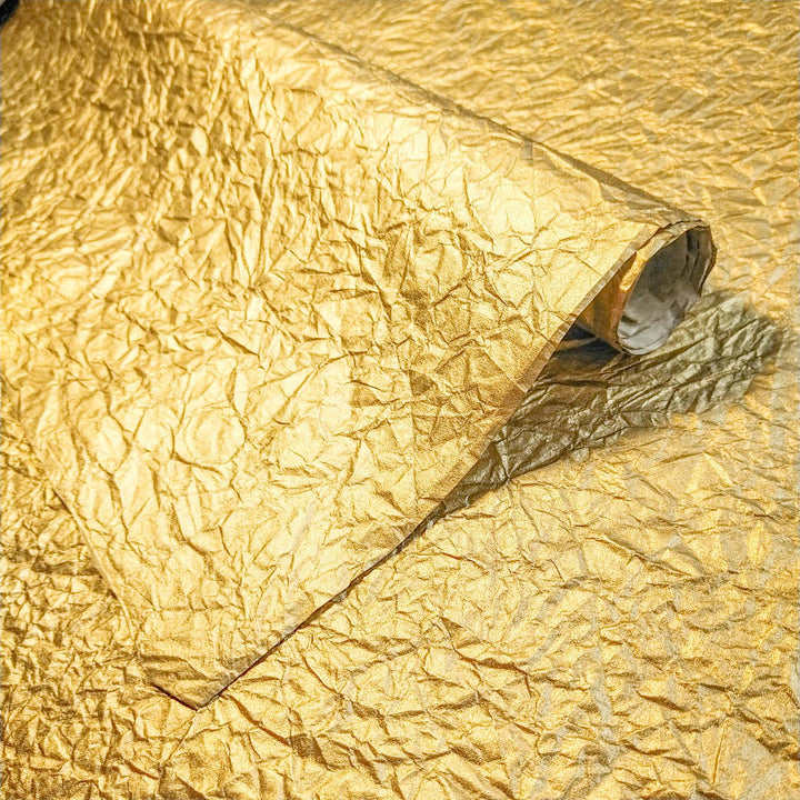 Metallic gold Momigami handmade paper from Kozo Studio featuring crumpled mulberry paper texture and a flexible fabric-like finish.