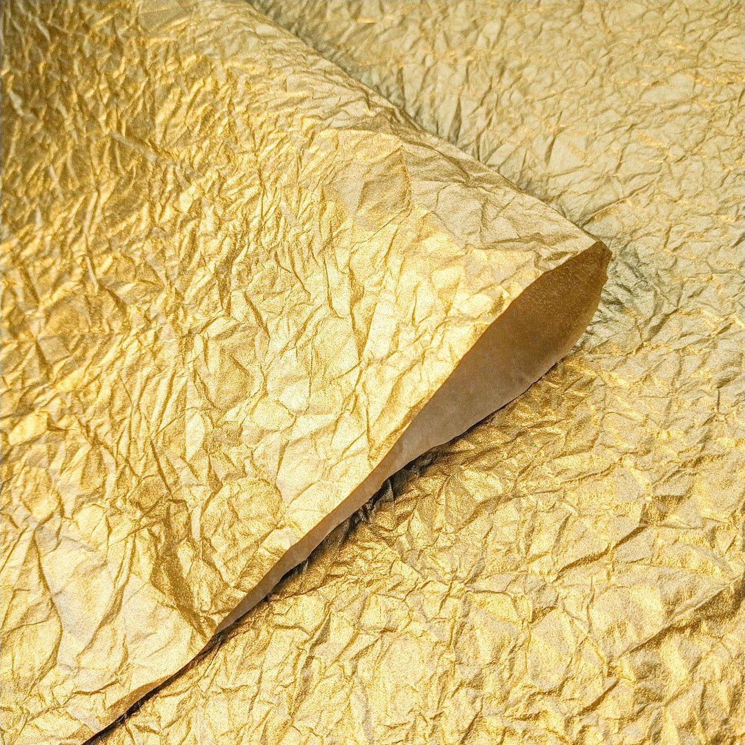 Crumpled gold metallic handmade paper made from mulberry fiber, showcased by Kozo Studio for artistic and craft use.