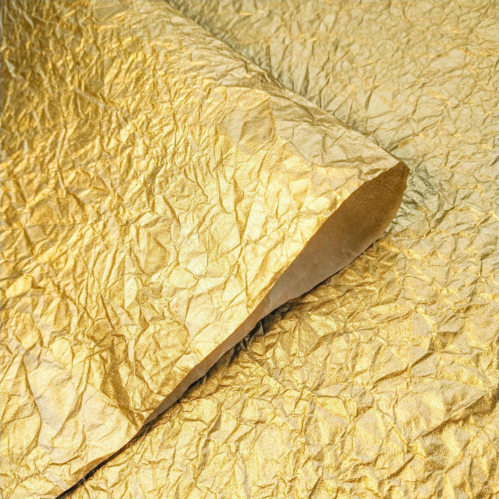 Crumpled gold metallic handmade paper made from mulberry fiber, showcased by Kozo Studio for artistic and craft use.