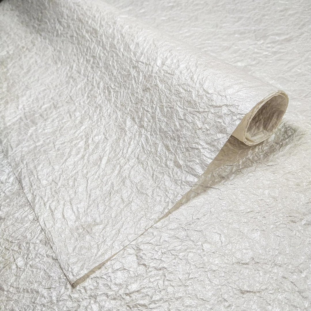 Close-up of Momigami Gleaming Metallic Kozo Paper in Pearl from Kozo Studio, showcasing its shiny metallic mulberry paper surface with a soft matte back.