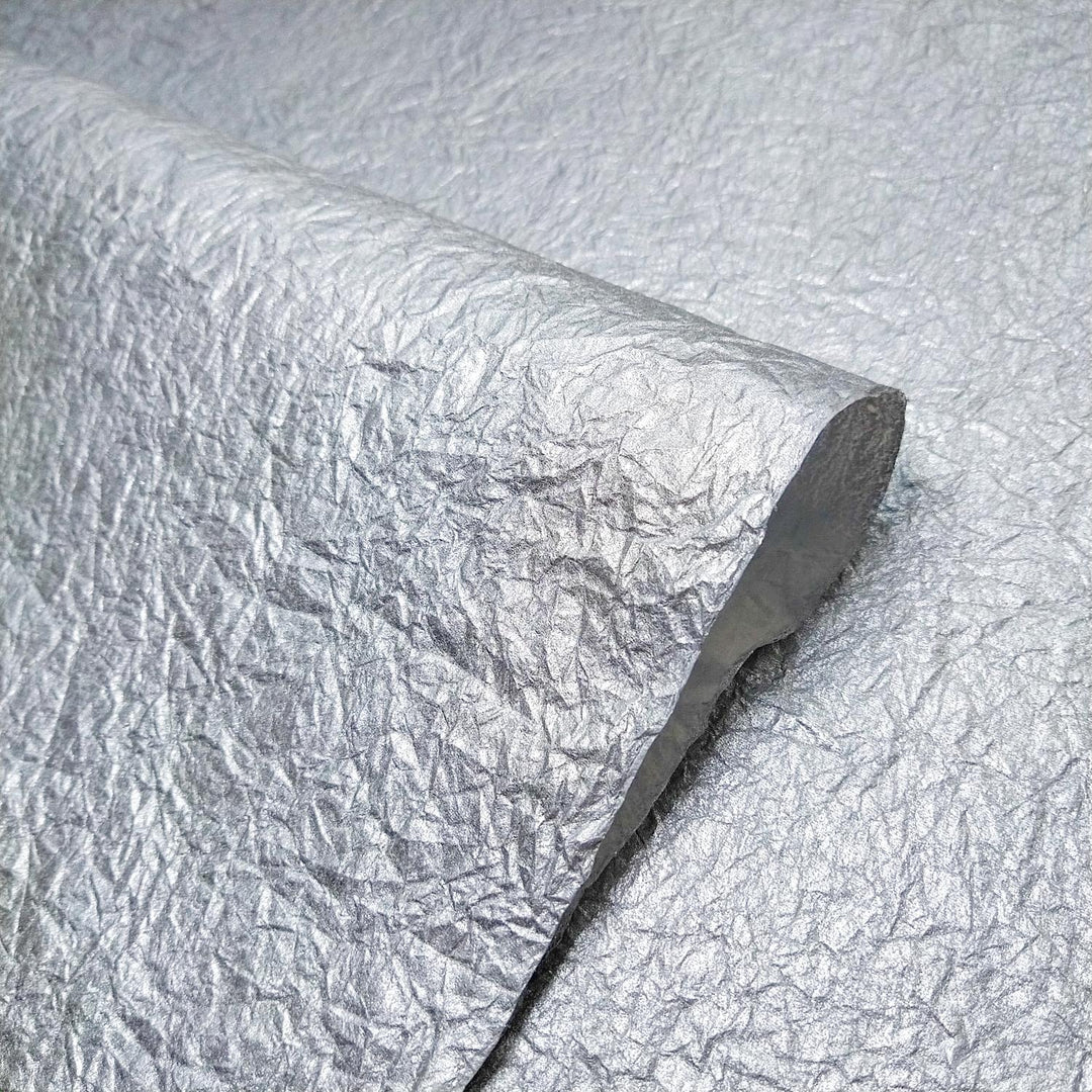 High-shine silver surface of Momigami Gleaming Metallic mulberry paper with matte contrast, a signature product from Kozo Studio.