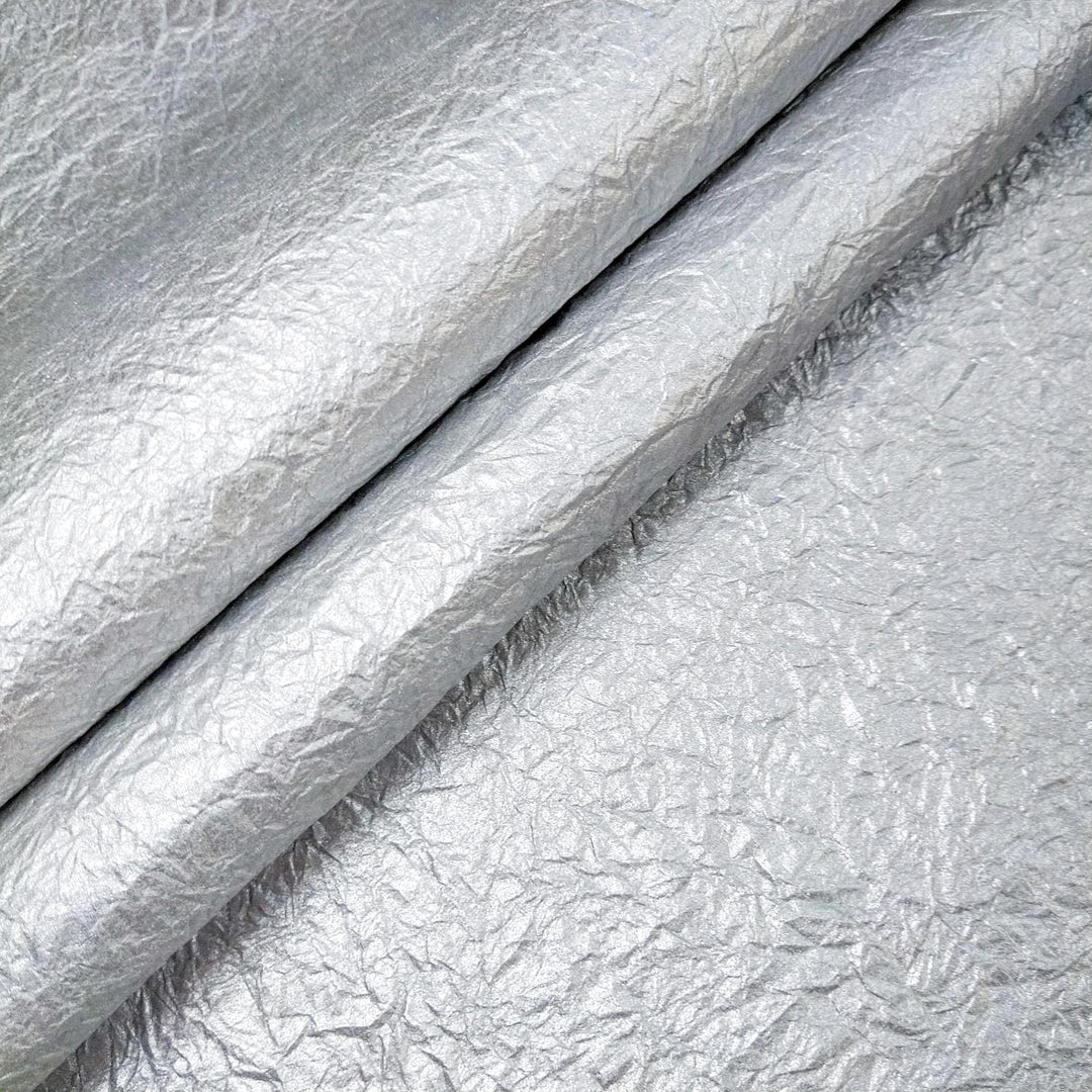 Handmade metallic mulberry paper with a unique crumpled design from Kozo Studio, perfect for craft and art projects.