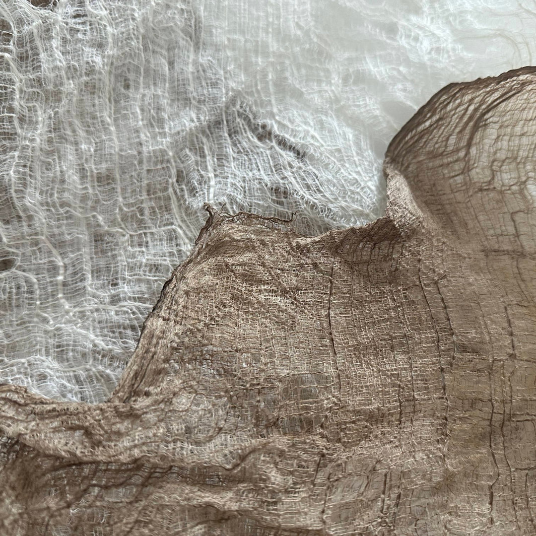 Image of high-quality mulberry bark from Kozo Studio, folded for shipping and ready for creative projects like stitching or coloring.