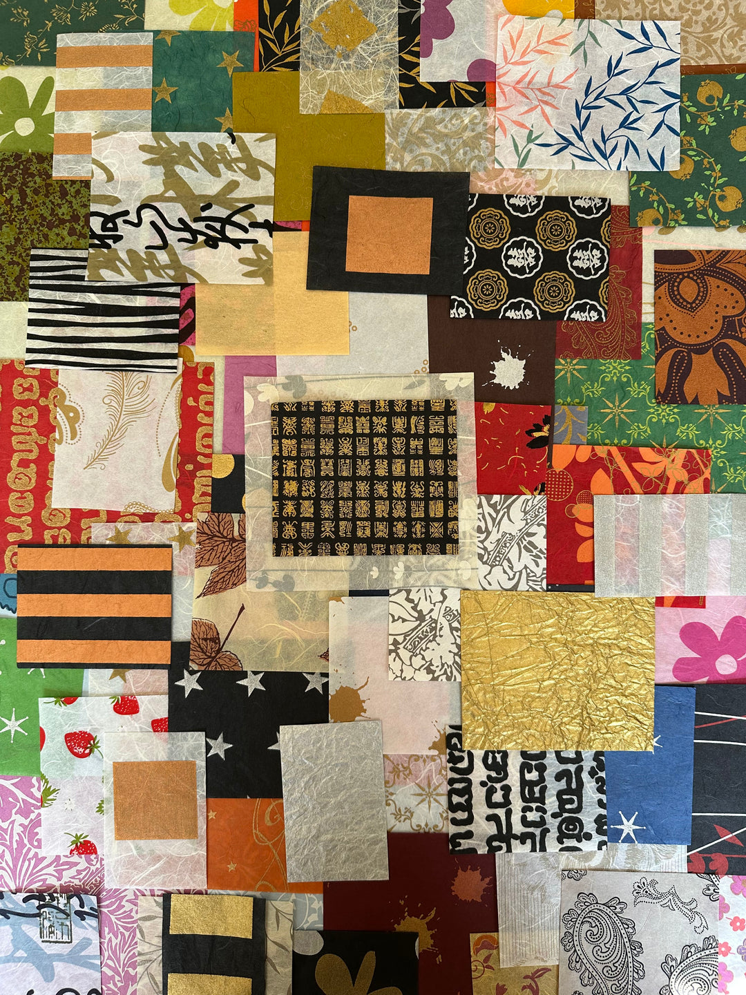Colorful handmade paper scraps from Kozo Studio’s Print Carnival pack, featuring 100 pieces of mulberry paper in floral, abstract, and geometric designs.