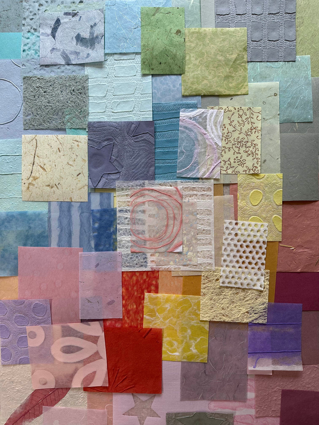 Pastel-toned 100-piece mulberry paper scrap pack by Kozo Studio, featuring unique handmade paper designs in assorted sizes for collage, scrapbooking, and crafts.