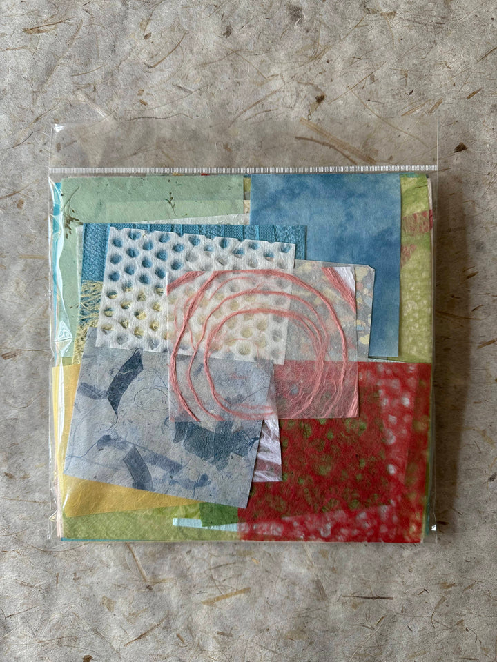 Close-up of pastel mulberry paper pieces from a Kozo Studio 100-piece handmade paper pack, highlighting the texture and variety in each uniquely curated sheet.