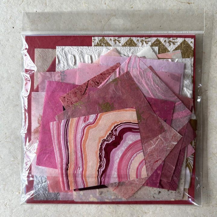 Detailed image of assorted mulberry paper scraps by Kozo Studio, featuring handmade paper pieces in varied sizes and textures, perfect for adding a personal touch to artistic creations.