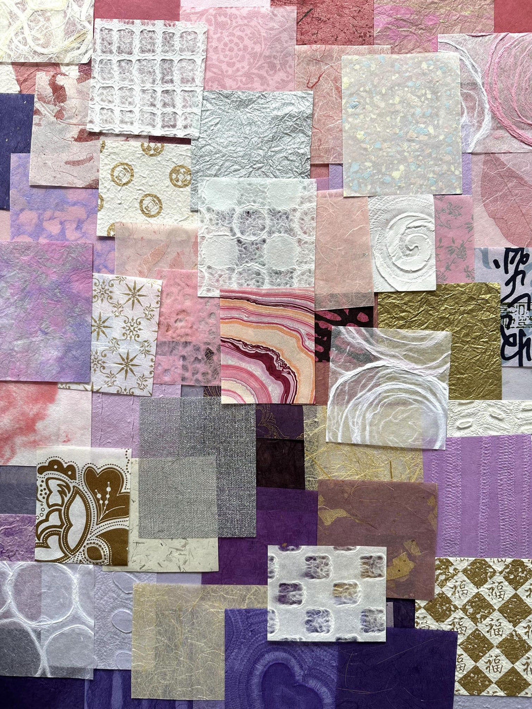 A vibrant 100-piece scrap pack of handmade mulberry paper from Kozo Studio, showcasing a unique mix of pink, purple, and white tones, ideal for creative projects like scrapbooking and collage making.