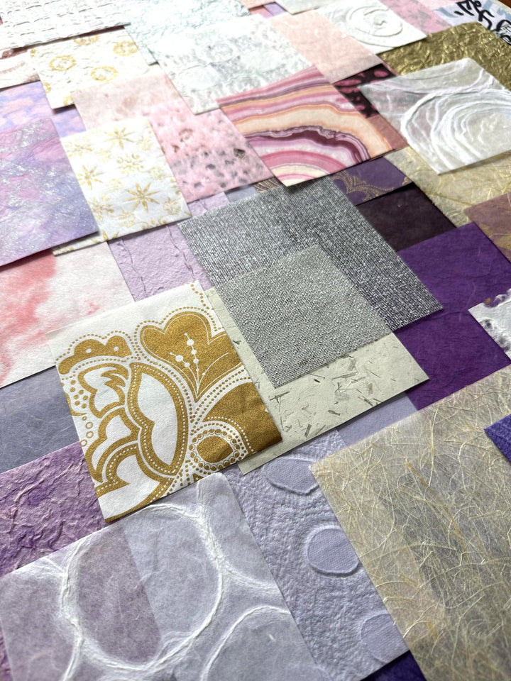 Colorful display of Kozo Studio’s 100-piece mulberry paper pack, highlighting the soft pink, purple, and white handmade paper designs curated for artistic versatility and DIY inspiration.