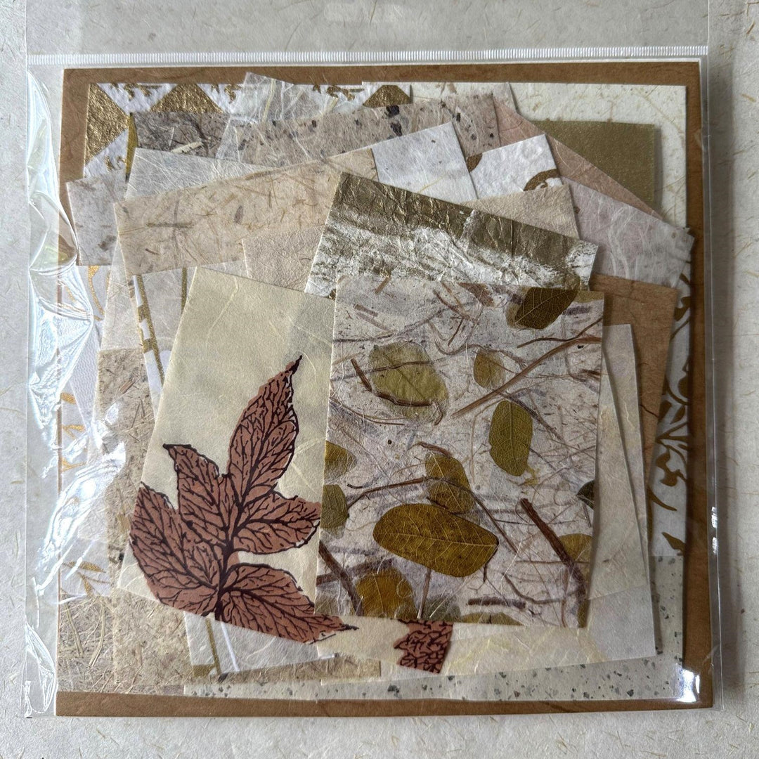 Artistic arrangement of 100 mulberry paper scraps by Kozo Studio, highlighting the variety of handmade paper designs and textures perfect for creative expression and mixed media art.