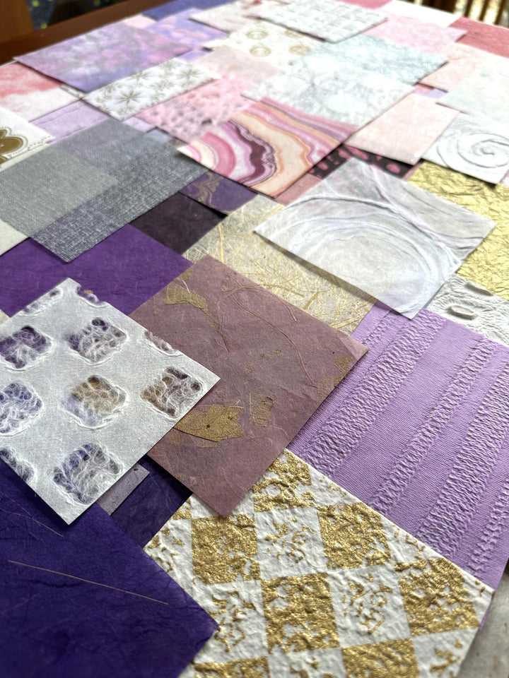 The Kozo Studio Mulberry Paper Scrap Pack: Forever Valentines edition features 100 textured rice paper squares in purple, gold, silver, and white with unique patterns like swirls and abstract designs, crafted to create a stunning patchwork effect.