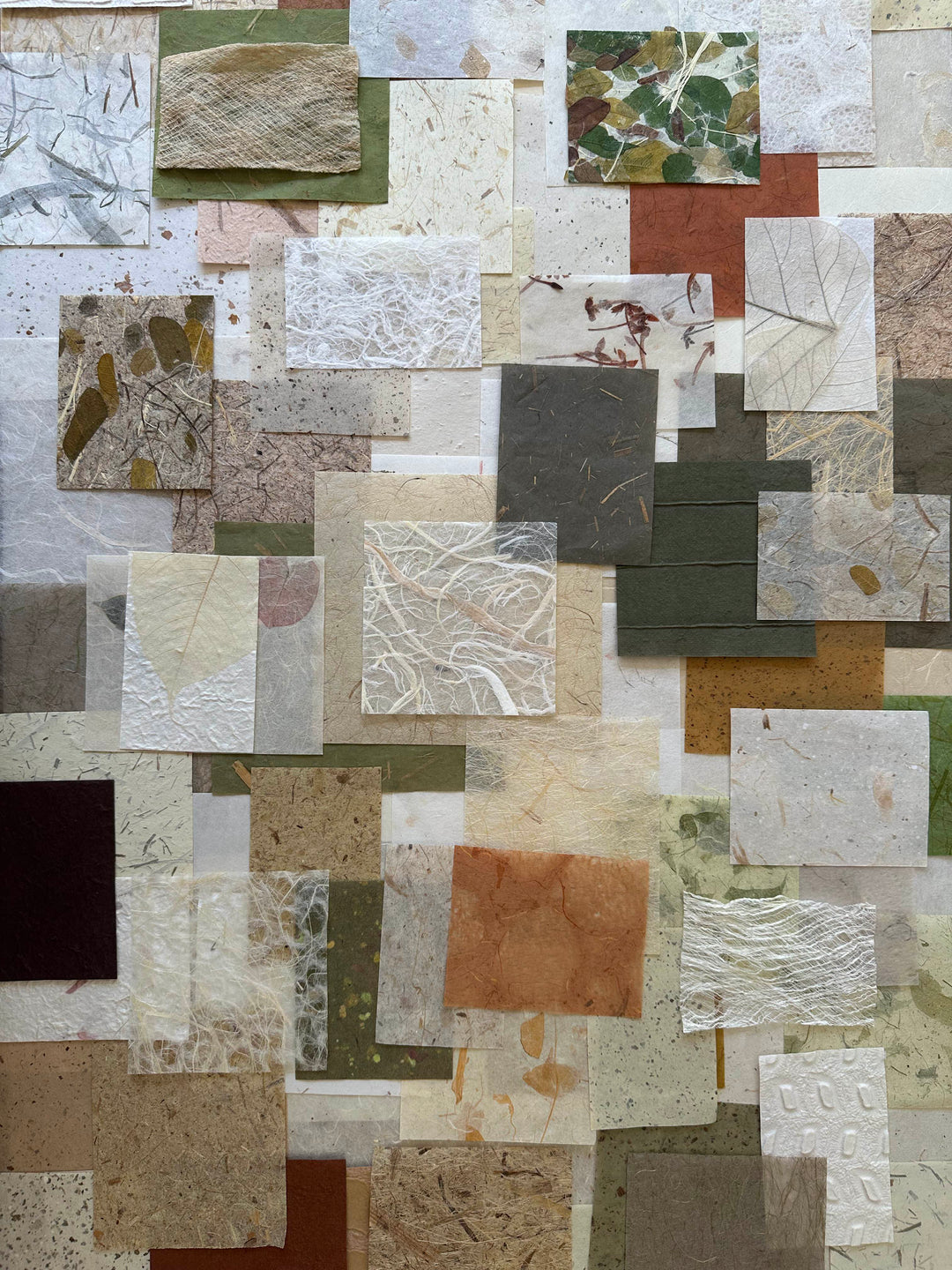 Kozo Studio handmade paper scrap pack with 100 pieces of mulberry paper in natural tones and leaf patterns.