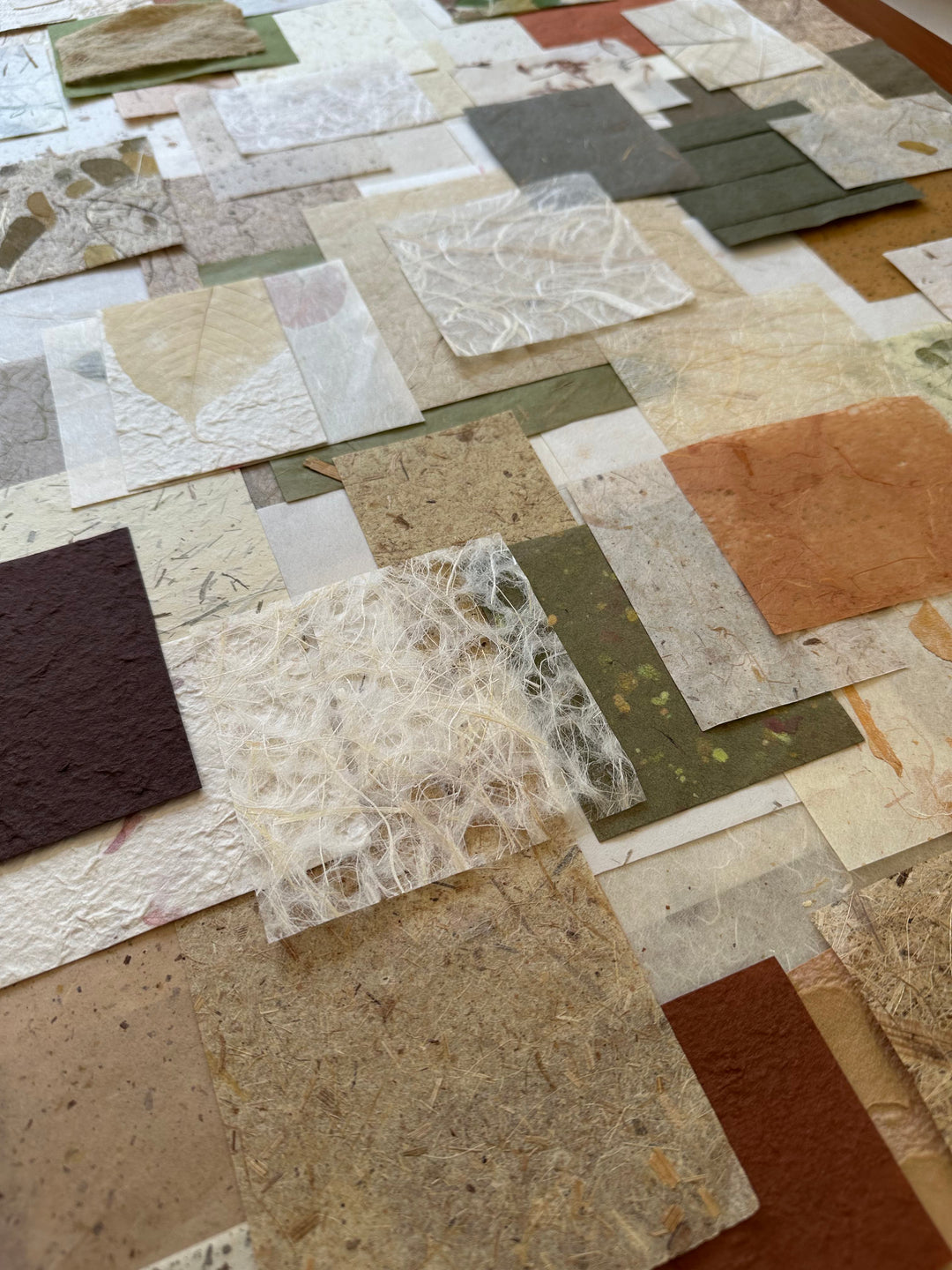 Handmade mulberry paper scraps from Kozo Studio's Garden Grove pack, showcasing leaf designs and earthy fibers.
