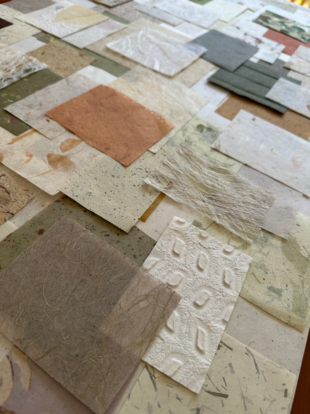 100-piece Kozo Studio mulberry paper pack with textured handmade paper in organic colors and patterns.
