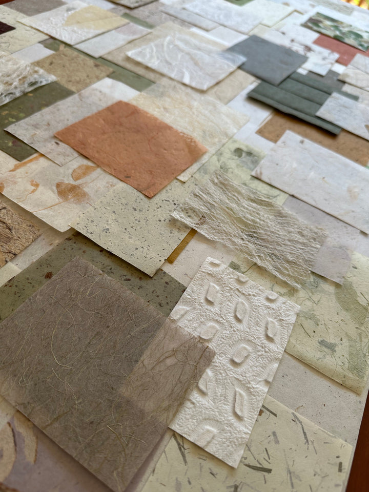 100-piece Kozo Studio mulberry paper pack with textured handmade paper in organic colors and patterns.