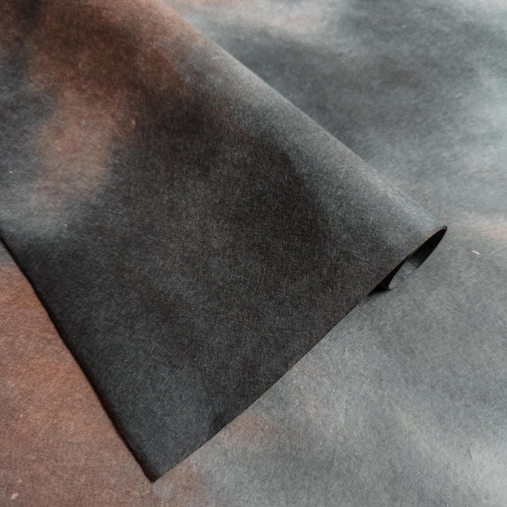 Artistic mulberry paper from Kozo Studio with a moody ombre palette of black, brown, and grey, perfect for scrapbooking, card making, and other handmade paper crafts.