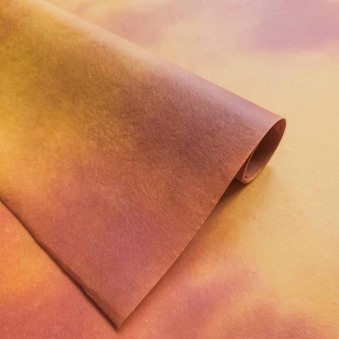 Hand-colored ombre handmade paper from Kozo Studio featuring a gradient of amber tones on premium mulberry paper, ideal for creative and decorative uses.