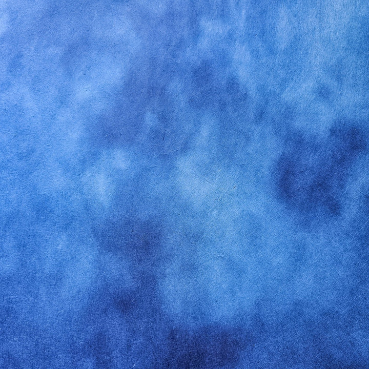 Artisan-crafted Kozo Studio mulberry paper with an ombre effect in vivid blue hues, a premium handmade paper choice for home décor, lampshades, and creative design work.